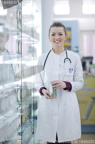 Image of pharmacist chemist woman standing in pharmacy drugstore