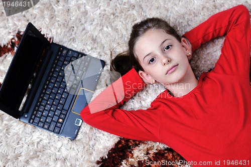 Image of happy school girl relaxing at home