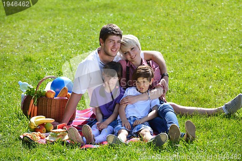 Image of Happy family playing together in a picnic outdoors