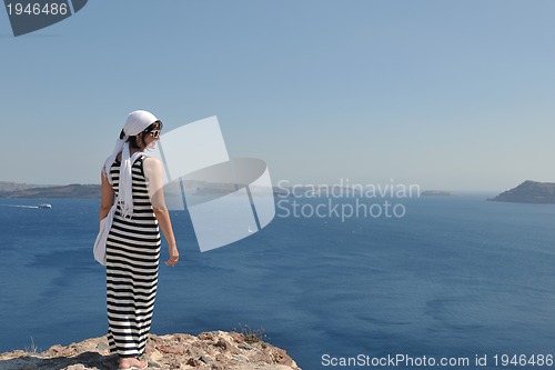 Image of Greek woman on the streets of Oia, Santorini, Greece