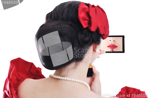 Image of beautiful young woman applying makeup
