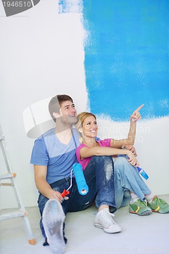 Image of happy young cople relaxing after painting in new home