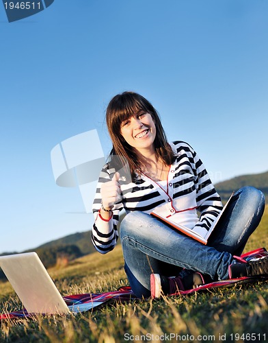 Image of young teen girl work on laptop outdoor