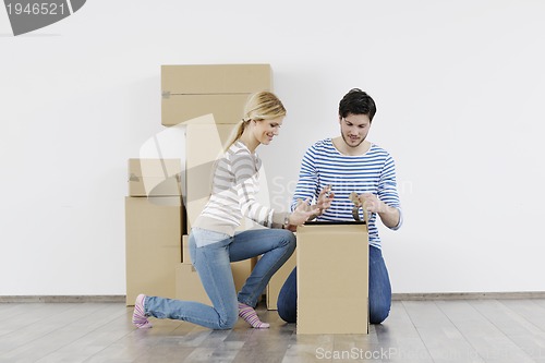 Image of Young couple moving in new home