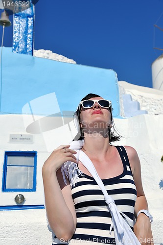 Image of Greek woman on the streets of Oia, Santorini, Greece