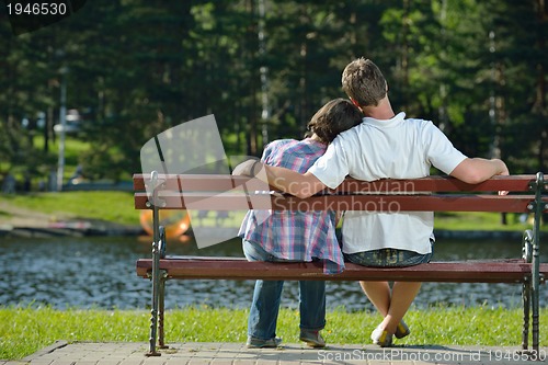 Image of Portrait of romantic young couple smiling together outdoor