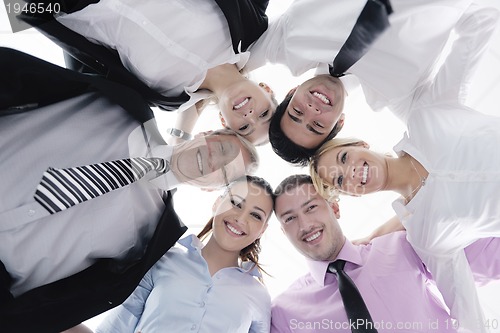 Image of business people with their heads together