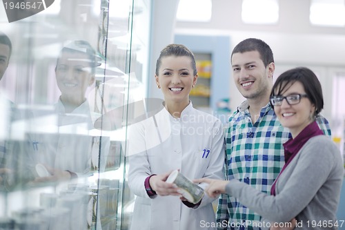 Image of pharmacist suggesting medical drug to buyer in pharmacy drugstor