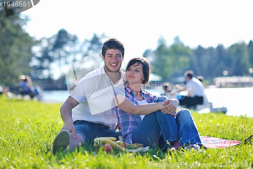 Image of happy young couple having a picnic outdoor