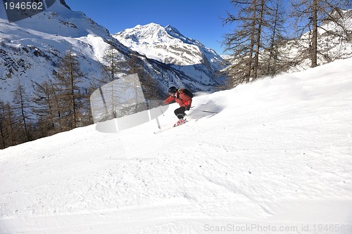 Image of skiing on fresh snow at winter season at beautiful sunny day