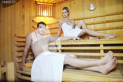 Image of happy young couple in sauna