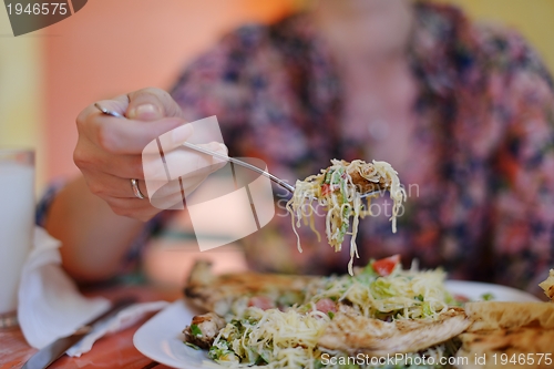 Image of woman eat salad