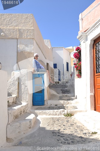 Image of Greek woman on the streets of Oia, Santorini, Greece