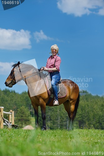 Image of happy woman  ride  horse