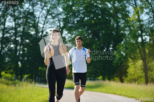 Image of Young couple jogging at morning