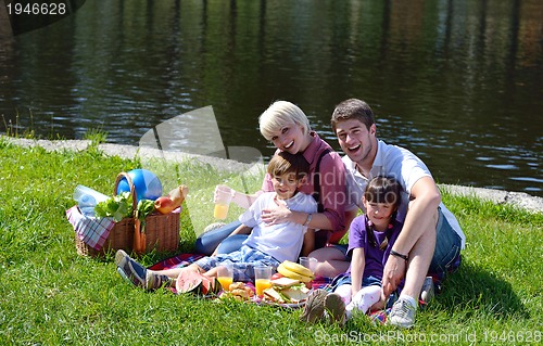 Image of Happy family playing together in a picnic outdoors