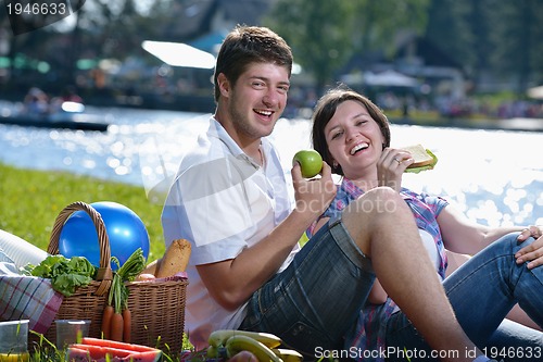 Image of happy young couple having a picnic outdoor