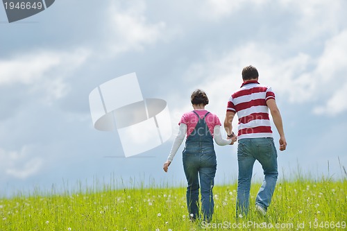 Image of Portrait of romantic young couple smiling together outdoor