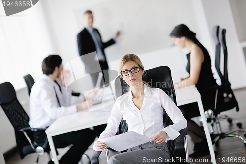 Image of business woman with her staff in background