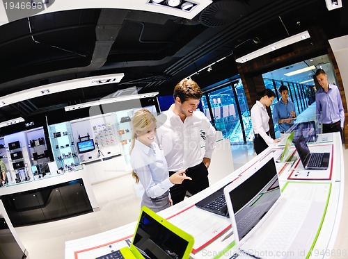 Image of Young couple in consumer electronics store