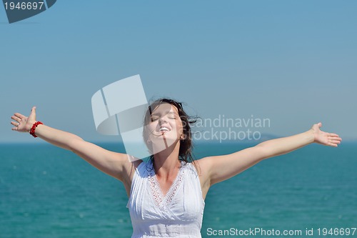 Image of happy young woman with spreading arms to sky