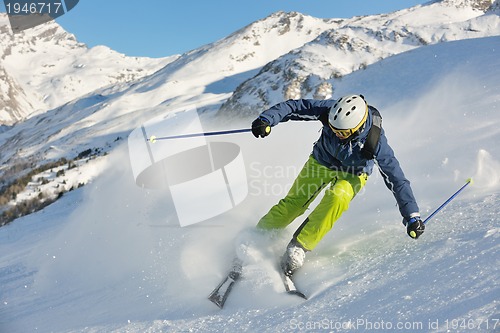 Image of skiing on fresh snow at winter season at beautiful sunny day