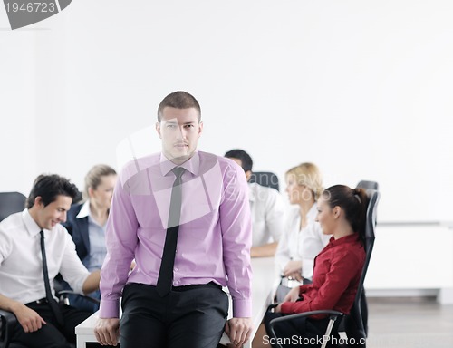 Image of young business man at meeting