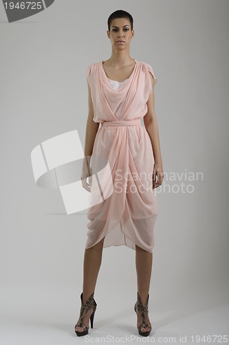 Image of elegant woman in fashionable dress posing in the studio