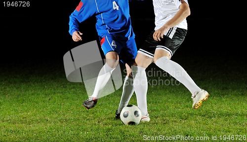 Image of football players in action for the ball