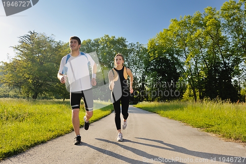 Image of Young couple jogging