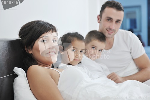 Image of happy young Family in their bedroom
