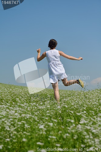 Image of Young happy woman in green field