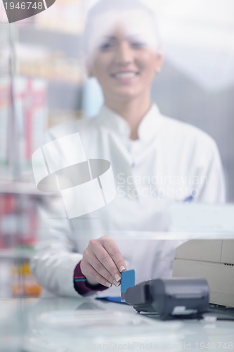 Image of pharmacist chemist woman standing in pharmacy drugstore