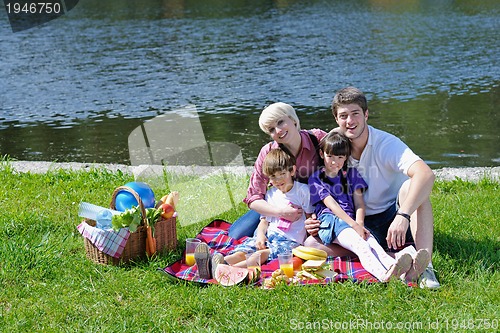 Image of Happy family playing together in a picnic outdoors