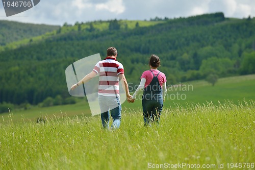 Image of Portrait of romantic young couple smiling together outdoor