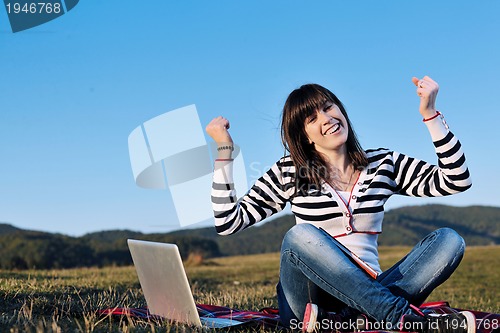 Image of young teen girl work on laptop outdoor