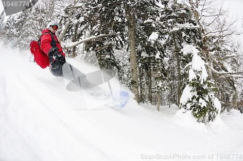 Image of snowboarder on fresh deep snow