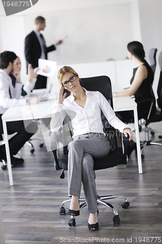 Image of business woman with her staff in background