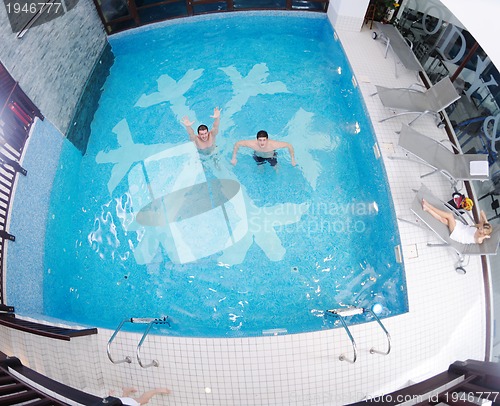 Image of young people group at spa swimming pool