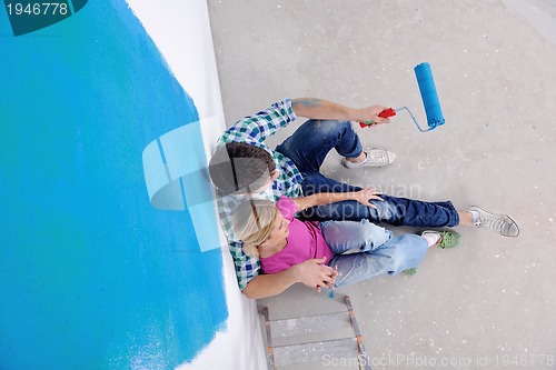 Image of happy young cople relaxing after painting in new home