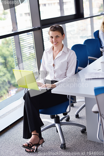 Image of Young pretty business woman with notebook in the office