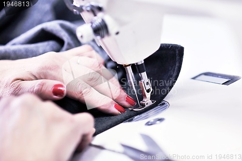 Image of Hands of Seamstress Using Sewing Machine