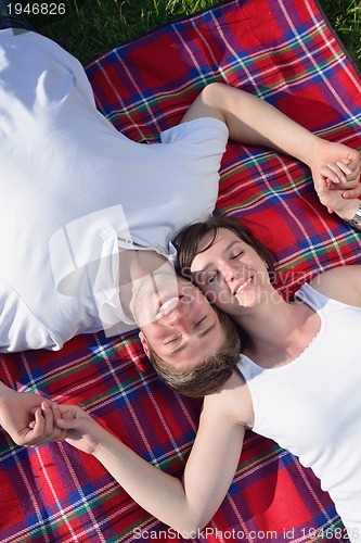 Image of happy young couple having a picnic outdoor