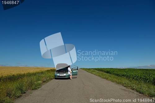 Image of woman with broken car