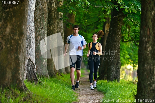 Image of Young couple jogging