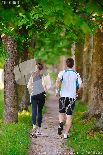 Image of Young couple jogging