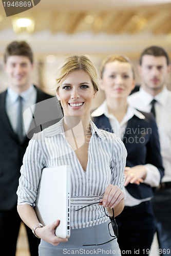 Image of business woman standing with her staff at conference