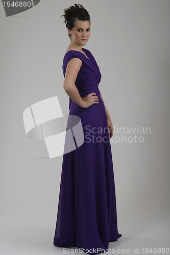 Image of elegant woman in fashionable dress posing in the studio