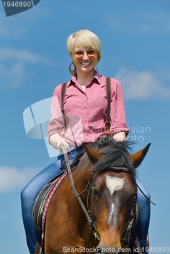 Image of happy woman  ride  horse