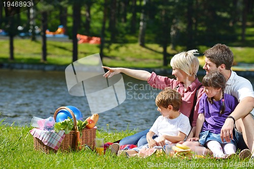 Image of Happy family playing together in a picnic outdoors